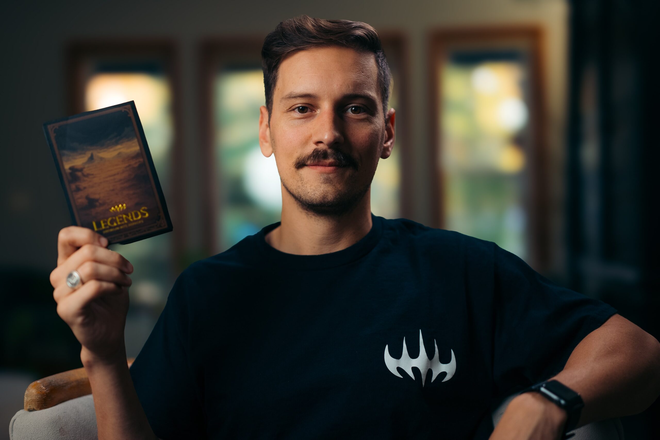 Man holding up box of Legends MTG